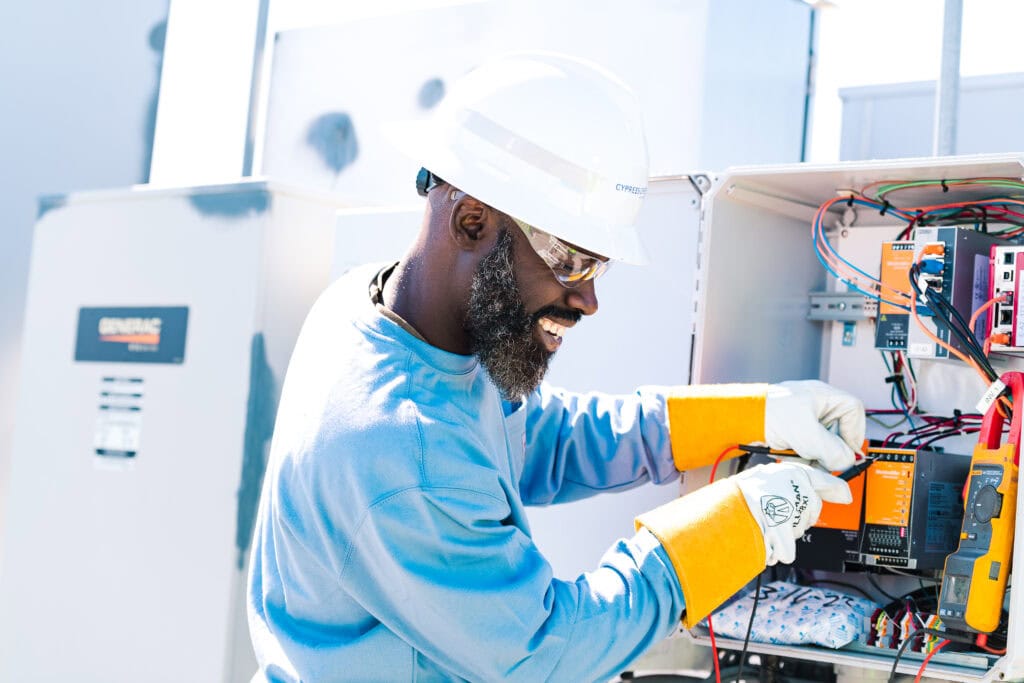 A technician working in an electrical panel.